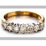 AN 18ct YELLOW AND WHITE GOLD DIAMOND RING, seven brilliant cut diamond in white gold claw