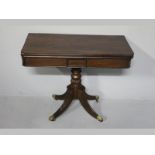 A REGENCY MAHOGANY TEA TABLE, the rectangular rotating top with a baize playing surface below with