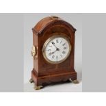 AN EDWARDIAN MAHOGANY AND WALNUT MANTLE CLOCK, the domed moulded top with a brass carrying handle