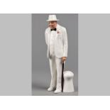 A ROYAL DOULTON "SIR WINSTON CHURCHILL" FIGURINE, dressed in a white suit holding a cane, base