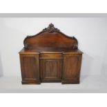 A VICTORIAN MAHOGANY DRESSER, the break-front with a moulded edge and carved back-rail above with