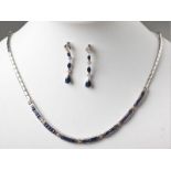 A 9ct WHITE GOLD AND SAPPHIRE NECKLACE, eight round brilliant cut diamonds interspaced with