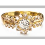AN 18ct YELLOW GOLD AND DIAMOND RING, centre round brilliant cut diamond surrounded by twelve
