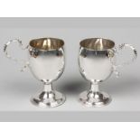 A PAIR OF GEORGIAN SILVER CUPS, LONDON 1811, W.H., applied C-scroll form handles with beaded
