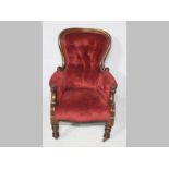 A VICTORIAN MAHOGANY ARMCHAIR, the arched moulded back-rail enclosing a deep button rest, the arms