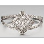 A 9ct WHITE GOLD AND DIAMOND RING, twenty-eight brilliant cut diamonds in pave setting with split