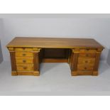 A PIERRE CRONJE TWIN PEDESTAL PARTNERS DESK IN MALAWIAN CEDARWOOD, the double moulded top above