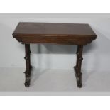 A VICTORIAN MAHOGANY CARD TABLE, the moulded rectangular top housing a gilt tooled baize plain