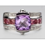 A 9ct WHITE GOLD, AMETHYST AND DIAMOND RING, amethyst tension set, shoulders set with two rows of