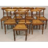 A SET OF EIGHT CAPE STINKWOOD DINING CHAIRS, the dished rails above spindle splats with cane seats