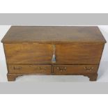 A GEORGIAN MAHOGANY MULE CHEST, the rectangular top above a storage space and candle box with two