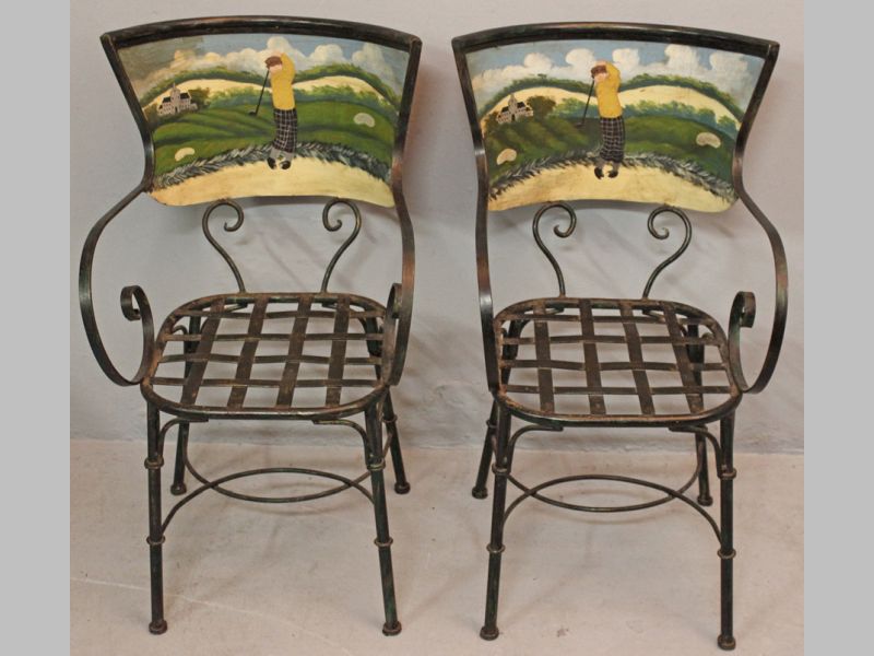 A PAIR OF WROUGHT IRON ARMCHAIRS, the backs depicting a golfing scene with scrolled arms above