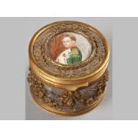 A FRENCH GLASS AND ORMOLU CIRCULAR BOX, the cover inset with a miniature of an officer, the gilded