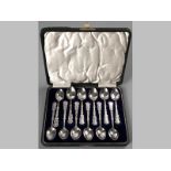 A SET OF TWELVE SILVER PRESENTATION SPOONS, BIRMINGHAM 1907, R.C., handles decorated with applied