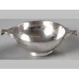 AN EDWARDIAN SILVER PORRINGER, BIRMINGHAM 1913, ELKINGTON & CO LTD., with twin handles, on a