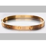 AN 8ct YELLOW GOLD CARTIER STYLE LOVE BANGLE, 24g.
