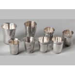 A COLLECTION OF EIGHT .800STD SILVER TOT MEASURES, various makers and sizes, some signed "L. Papap",
