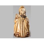 A CHINESE CARVED STAINED IVORY FIGURE OF A SAGE, 20TH CENTURY, his hands concealed within his long