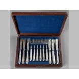 A TWELVE PLACE SILVERPLATE FISH CUTLERY, the blades engraved with fish and scrolls, the handles