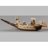 A LATE 19TH CENTURY JAPANESE STAINED SECTIONAL IVORY CARVING OF A FISHING BOAT, the seated fisherman