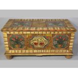 AN EARLY 19TH CENTURY SOUTH GERMAN PAINTED CHEST, the moulded top wih three panels, the centre panel