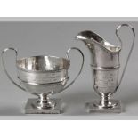 A GEORGE V SILVER CREAMER AND SUGAR BASIN, LONDON 1913, G.B. & S., with reeded elongated C-form