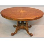 A LATE VICTORIAN WALNUT OVAL CENTRE TABLE, the quartered top with an inlaid floral panel, the frieze
