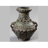 A CHINESE BRONZE VASE, heavily decorated with loose ring handles around the base and body of the