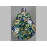 A CIRCULAR MAJOLICA PILGRIM'S FLASK, decorated with a geometric design in blue, green and yellow,