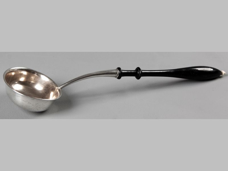 AN .800STD SILVER TODDY LADLE, with ebony handle and ivory finial, gilded bowl, 36cm long.