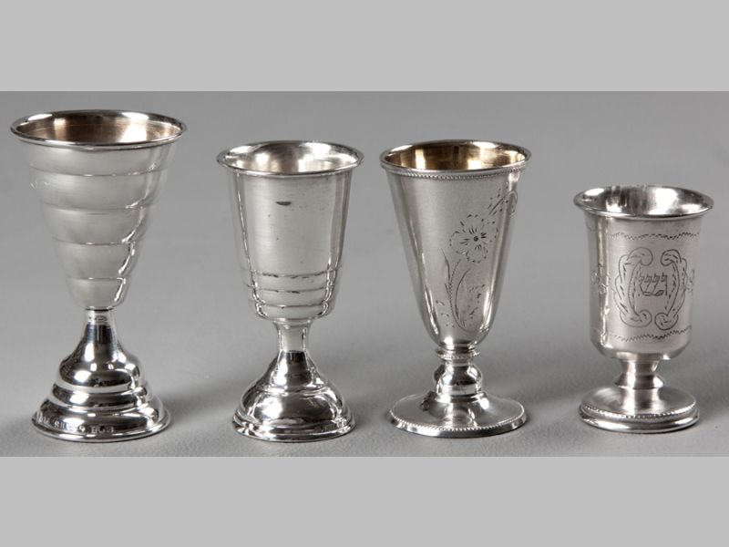 A COLLECTION OF FOUR POLISH SILVER KIDDUSH CUPS, all similarly decorated with pin-prick