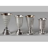 A COLLECTION OF FOUR POLISH SILVER KIDDUSH CUPS, all similarly decorated with pin-prick