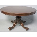 A VICTORIAN MAHOGANY DINING TABLE, the circular top with a beaded frieze, standing on a tapering and