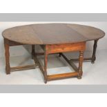 AN 18th CENTURY CAPE TEAK DROP LEAF TABLE, the peg top and leaves consisting of single boards, the