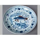 A FINE LARGE CHINESE SAUCER DISH, decorated in the Ming style in underglaze red and blue with a