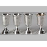 A COLLECTION OF FOUR CONTINENTAL .800STD SILVER KIDDUSH CUPS, all similarly decorated with fold-over