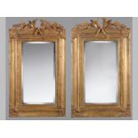 A PAIR OF GILT FRAMED MIRRORS, the top-rails decorated with laurel and ribbons, the corners with