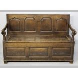 AN EARLY 18TH CENTURY ENGLISH OAK BENCH, the wainscot back with four moulded cushion panels, above