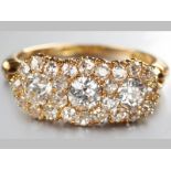 AN 18CT YELLOW GOLD AND DIAMOND RING, claw-set with twenty-six diamonds of approximately 1.2cts in