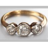 AN 18CT YELLOW GOLD AND DIAMOND RING, three tube set diamonds ending on a solid shank, diamonds of