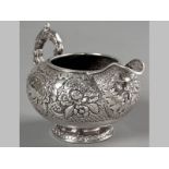 A GEORGE IV SILVER CREAMER DUBLIN 1922, JAMES SCOTT, spout embossed with caryatid mask, leaf