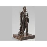 A BRONZE SCULPTURE OF A GENTLEMAN, dark patina, standing on a square marble base, 30cm high (