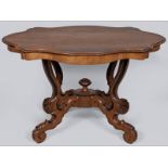 A VICTORIAN MAHOGANY CENTRE TABLE, the serpentine top with a moulded edge and frieze, standing on