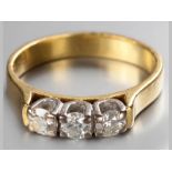 AN 18CT YELLOW GOLD AND DIAMOND RING, three diamonds claw set, ending on a solid shank, diamonds