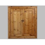 A LATE 19TH CENTURY CAPE PINE MUURKAS, the rectangular moulded frame, the panelled doors revealing a