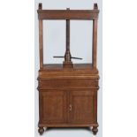 A 19TH CENTURY DUTCH OAK LINEN PRESS, the moulded top with gables above a large screw press,