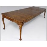 A HANDSOME EDWARDIAN WALNUT RECTANGULAR EXTENDING DINING TABLE, in the Mid-Georgian style, the