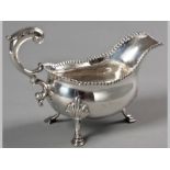 A GEORGE III SILVER SAUCE BOAT LONDON 1768, WILLIAM SHAW, with gadrooned serpentine rim, fancy C-