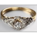 AN 18CT YELLOW AND WHITE GOLD DIAMOND RING, claw set diamond on raised decorated base with diamond