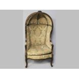 A CARVED AND UPHOLSTERED PORTER'S CHAIR, in the French manner, the top-rail with foliate carving,